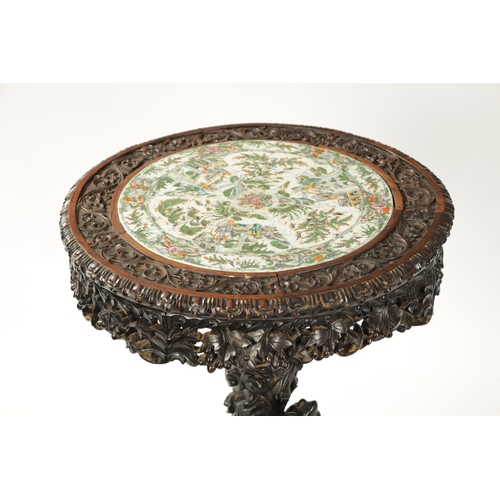 112 - A FINE 19TH CENTURY CHINESE PROFUSELY CARVED CENTRE TABLE WITH CANTONESE PORCELAIN INSET TOP the int... 