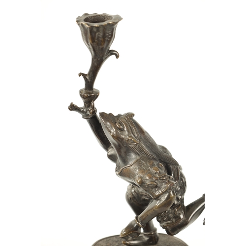 114 - A PAIR OF JAPANESE MEIJI PERIOD PATINATED BRONZE FIGURAL CANDLESTICKS each modelled as a frog warrio... 