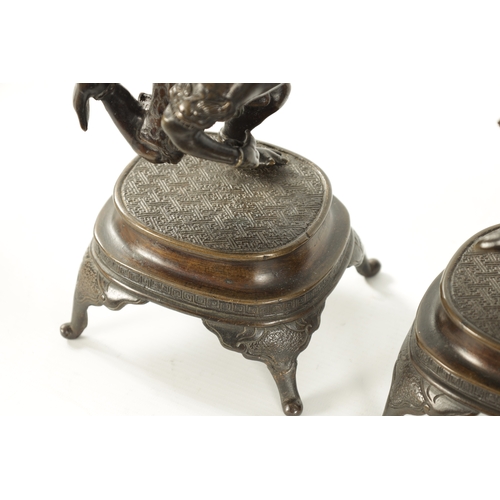 114 - A PAIR OF JAPANESE MEIJI PERIOD PATINATED BRONZE FIGURAL CANDLESTICKS each modelled as a frog warrio... 