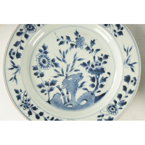 117 - A PAIR OF 18TH CENTURY CHINESE BLUE AND WHITE PLATES decorated with floral sprays. (28cm diameter )