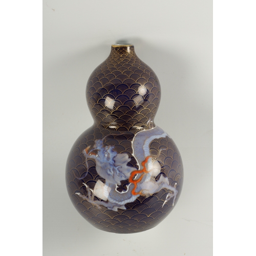 124 - A LATE 19TH CENTURY JAPANESE PORCELAIN DOUBLE GOURD CABINET VASE with entwined dragon decoration on ... 