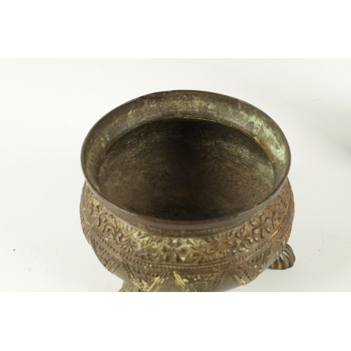 131 - AN EARLY EASTERN BRONZE FOOTED BOWL with floral design edge; raised on paw feet (9.5cm high 14cm dia... 