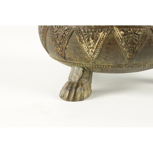 131 - AN EARLY EASTERN BRONZE FOOTED BOWL with floral design edge; raised on paw feet (9.5cm high 14cm dia... 