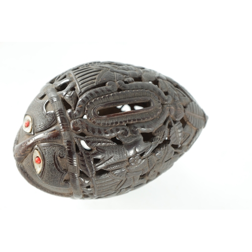 132 - AN EARLY 19TH CENTURY EASTERN CARVED COCONUT BUGBEAR MONEYBOX with a grotesque face and inlaid eyes ... 