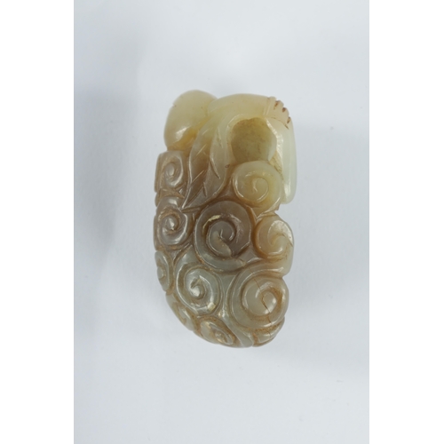 133 - A CHINESE CARVED RUSETT JADE MONKEY perched in a floral setting. (5cm high )