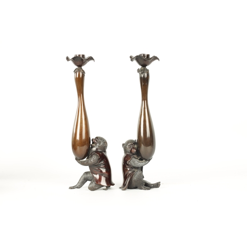 139 - A FINE PAIR OF JAPANESE MEIJI PATINATED BRONZE FIGURAL CANDLESTICKS the plain slender ovoid vase sha... 