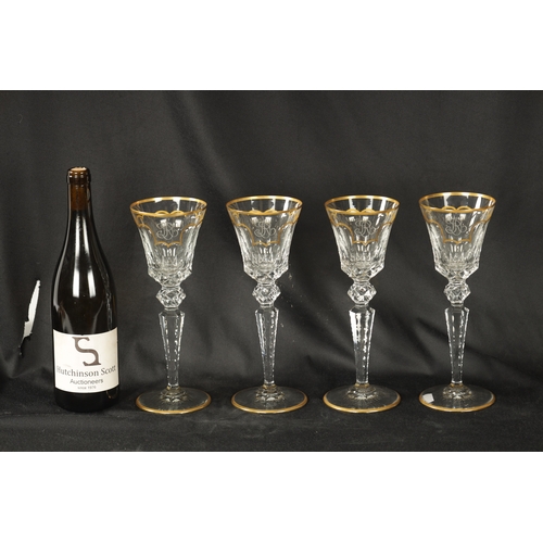 14 - A SET OF FOUR ST LOUIS CRYSTAL CUT GLASS WINE GLASSES with fluted bowls and hobnail cut stems decora... 