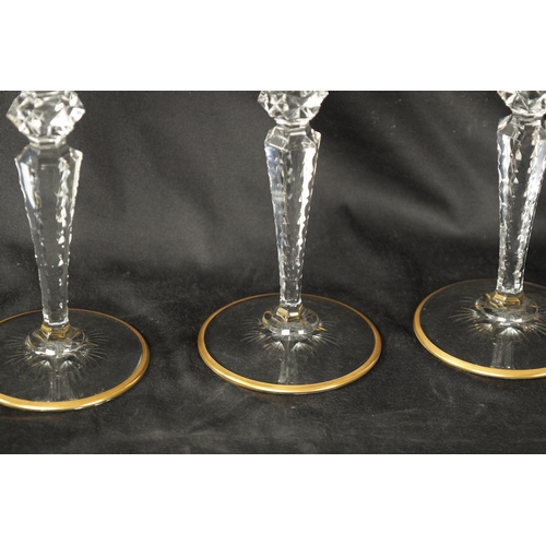 14 - A SET OF FOUR ST LOUIS CRYSTAL CUT GLASS WINE GLASSES with fluted bowls and hobnail cut stems decora... 