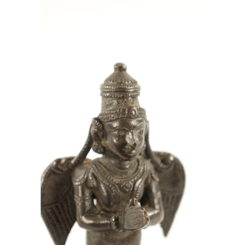 142 - AN EARLY INDIAN CAST BRONZE FIGURE OF A HINDU DEITY with hands closed and standing on a circular bas... 