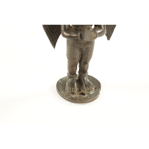 142 - AN EARLY INDIAN CAST BRONZE FIGURE OF A HINDU DEITY with hands closed and standing on a circular bas... 