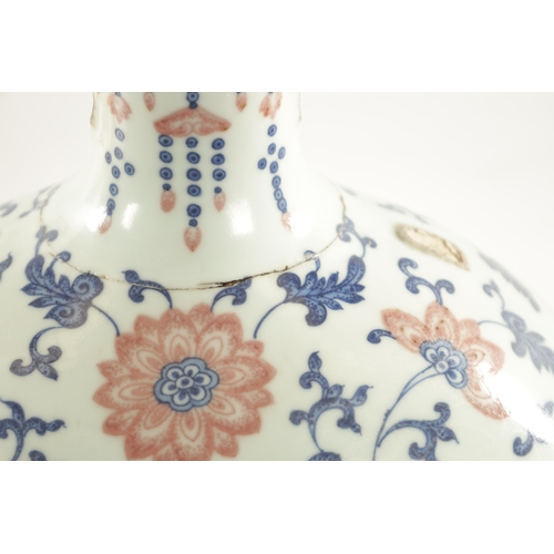 150 - A LARGE CHINESE AUBERGINE, BLUE AND WHITE PORCELAIN MOON FLASK with scrollwork and flowerhead design... 