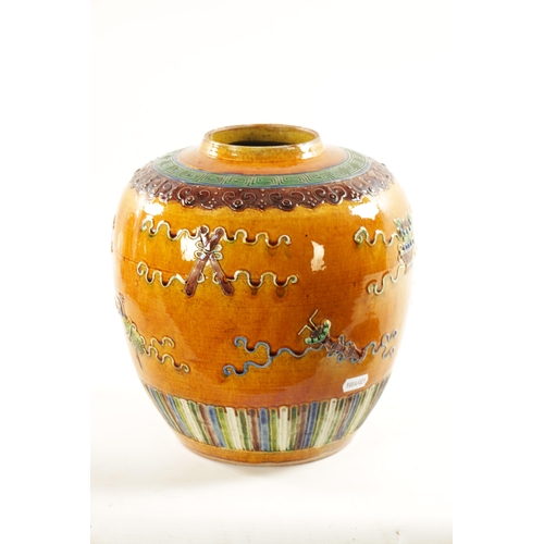 151 - A CHINESE BISCUIT GLAZED GINGER JAR having raised decoration of various vases and instruments and la... 