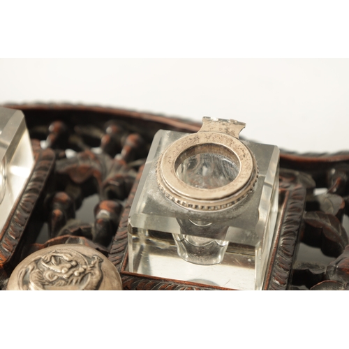 152 - A 19TH CENTURY CHINESE CARVED HARDWOOD AND SILVER MOUNTED DESK SET with dished silver pen tray and c... 