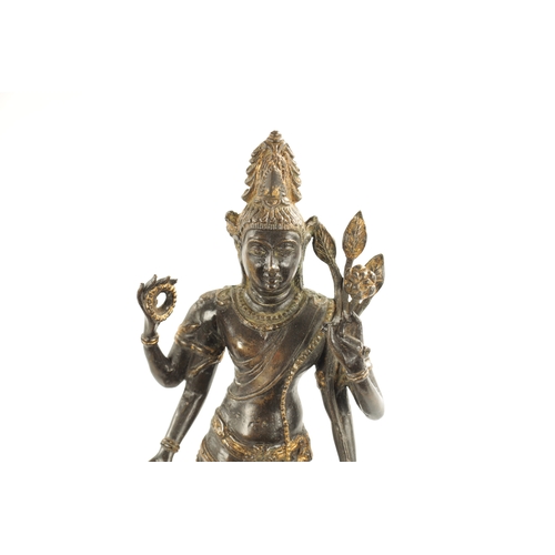 156 - AN EARLY BRONZE AND GILT BRONZE INDIAN FIGURE OF TARA mounted on a wooden base (36cm high )