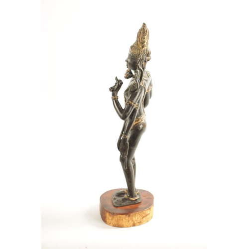 156 - AN EARLY BRONZE AND GILT BRONZE INDIAN FIGURE OF TARA mounted on a wooden base (36cm high )