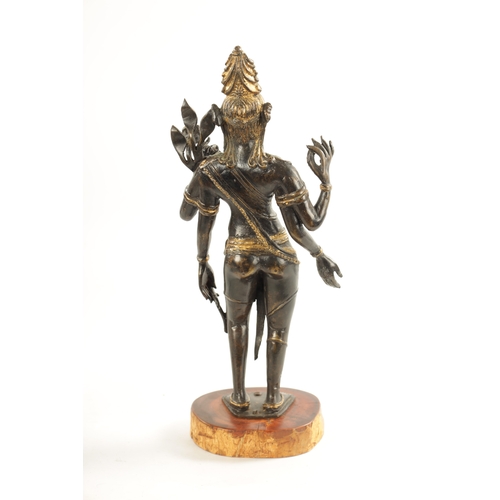 156 - AN EARLY BRONZE AND GILT BRONZE INDIAN FIGURE OF TARA mounted on a wooden base (36cm high )