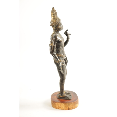 156 - AN EARLY BRONZE AND GILT BRONZE INDIAN FIGURE OF TARA mounted on a wooden base (36cm high )