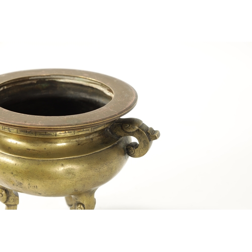 164 - AN 18TH/19TH CENTURY CHINESE CAST BRONZE CENSOR of bulbous form, elephant trunk handles; raised on t... 