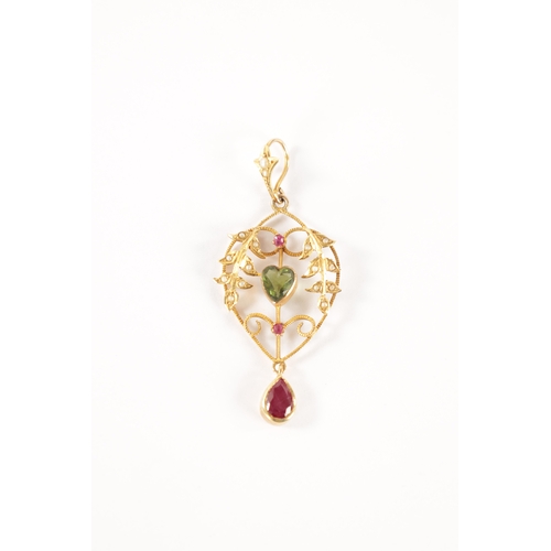 180 - A LATE 19TH CENTURY GOLD, RUBY AND PEARL SUFFRAGETTE PENDANT the open work floral frame with pearl s... 