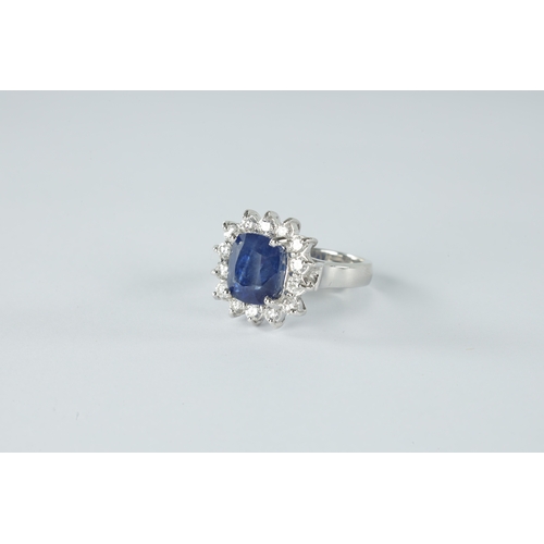 188 - A LADIES LARGE 18CT WHITE GOLD SAPPHIRE AND DIAMOND RING the cushion shaped sapphire app. 3.0ct surr... 