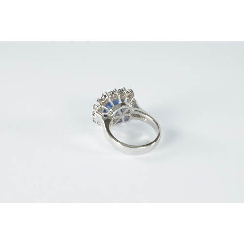 188 - A LADIES LARGE 18CT WHITE GOLD SAPPHIRE AND DIAMOND RING the cushion shaped sapphire app. 3.0ct surr... 