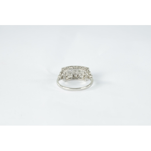 189 - A LADIES ART DECO PLATINUM AND DIAMOND RING with 19 brilliant diamonds in a rubover setting on a pie... 