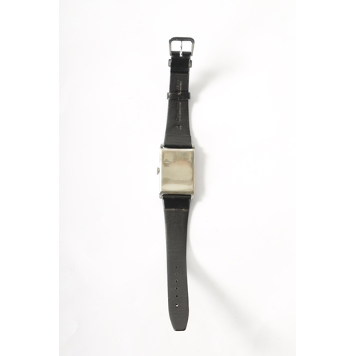 231 - A GENTLEMEN’S 1930’S NICKEL CASED JUMP HOUR WRISTWATCH on black leather strap, the rectangular case ... 