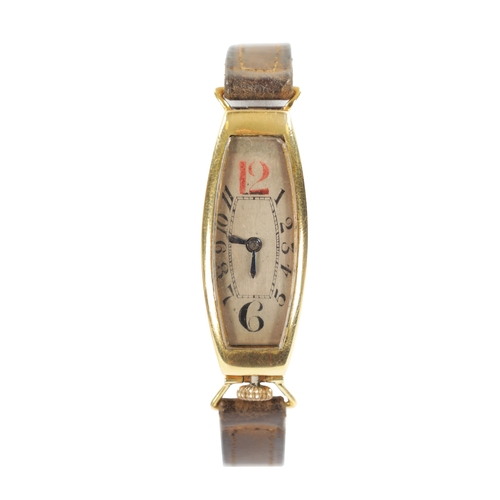 247 - A 1920'S 18CT GOLD ART DECO 'TONNEAU' WRISTWATCH the silvered oval dial with Arabic chaptering, red ... 