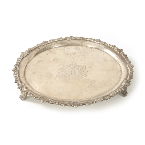 275 - A GEORGE III SILVER CIRCULAR SALVER of heavy gauge silver plain centre and embossed gadrooned rim wi... 