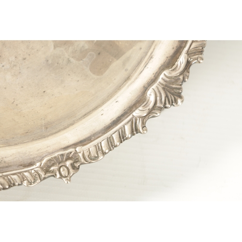 275 - A GEORGE III SILVER CIRCULAR SALVER of heavy gauge silver plain centre and embossed gadrooned rim wi... 