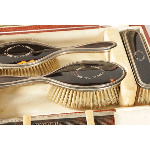 280 - AN EARLY 20TH CENTURY SILVER AND TORTOISESHELL SIX PIECE CASED DRESSING TABLE SET comprising of a mi... 