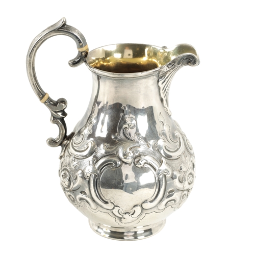 281 - A MID 19TH CENTURY SILVER AND SILVER GILT ALE JUG of bulbous form with embossed rococo style swagwor... 