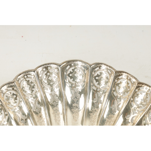 290 - A PAIR OF SILVER PIERCED ENGRAVED SCOLLOP SHELL BON BON DISHES each raised on three domed feet, tota... 