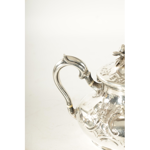 294 - A LATE REGENCY SILVER TEAPOT decorated with rococo style leafwork scrolls and rose finial with bone ... 