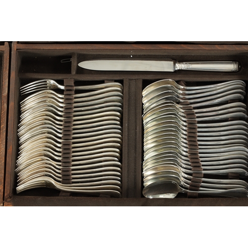 297 - A LARGE EARLY 20TH CENTURY 24SERVING FRENCH CHRISTOFLE SILVER PLATED CUTLERY SET in two fitted oak b... 