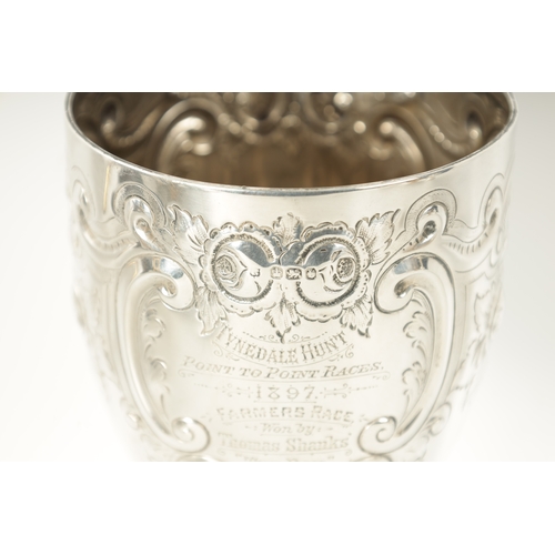 300 - A LATE 19TH CENTURY SILVER GOBLET having embossed decoration with inscription dated 1897 by James De... 