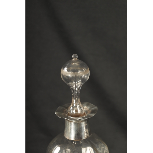 301 - A LATE 19TH CENTURY SILVER MOUNTED GLASS DECANTER of shaped form with crimped edge and silver neck w... 