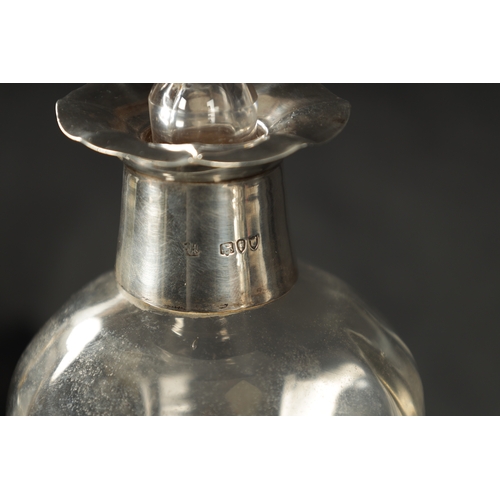 301 - A LATE 19TH CENTURY SILVER MOUNTED GLASS DECANTER of shaped form with crimped edge and silver neck w... 