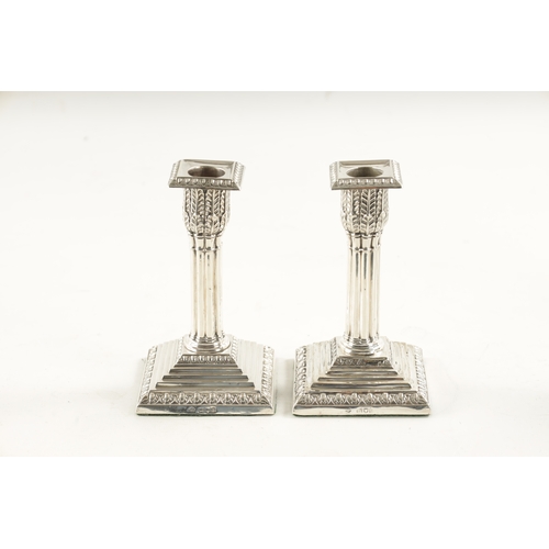 303 - A PAIR OF LATE 19TH CENTURY SILVER CANDLESTICKS having reeded stems and stepped square loaded bases.... 