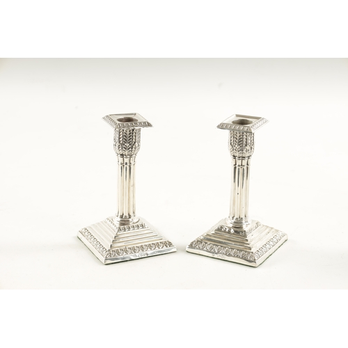 303 - A PAIR OF LATE 19TH CENTURY SILVER CANDLESTICKS having reeded stems and stepped square loaded bases.... 