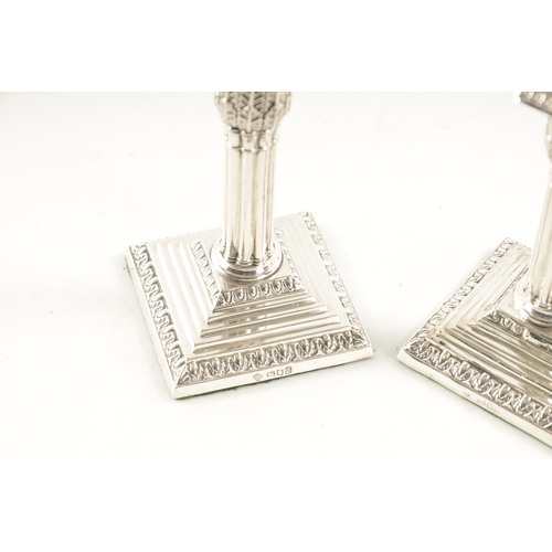 303 - A PAIR OF LATE 19TH CENTURY SILVER CANDLESTICKS having reeded stems and stepped square loaded bases.... 