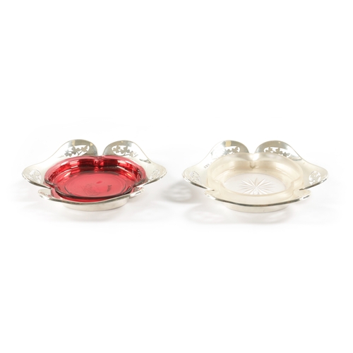 304 - A MATCHED PAIR OF EARLY 20TH CENTURY SILVER AND GLASS PIN TRAYS of petal shape with ruby and frosted... 