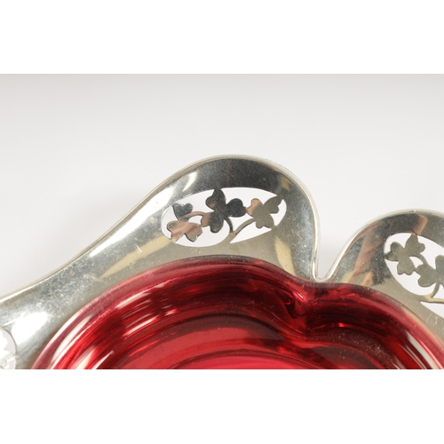 304 - A MATCHED PAIR OF EARLY 20TH CENTURY SILVER AND GLASS PIN TRAYS of petal shape with ruby and frosted... 