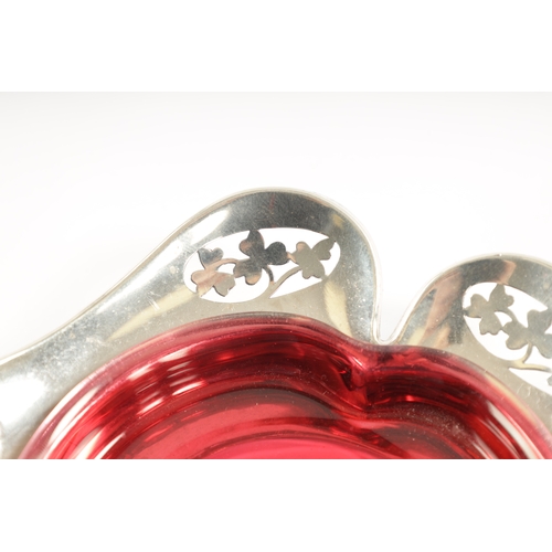 304 - A MATCHED PAIR OF EARLY 20TH CENTURY SILVER AND GLASS PIN TRAYS of petal shape with ruby and frosted... 