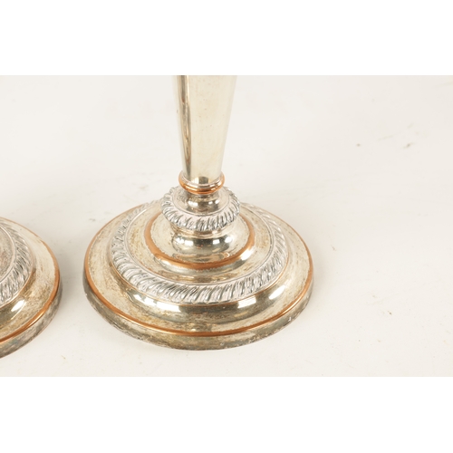 306 - TWO OLD SHEFFIELD SILVER PLATED CANDLESTICKS with tapered stems and circular bases (22cm high)