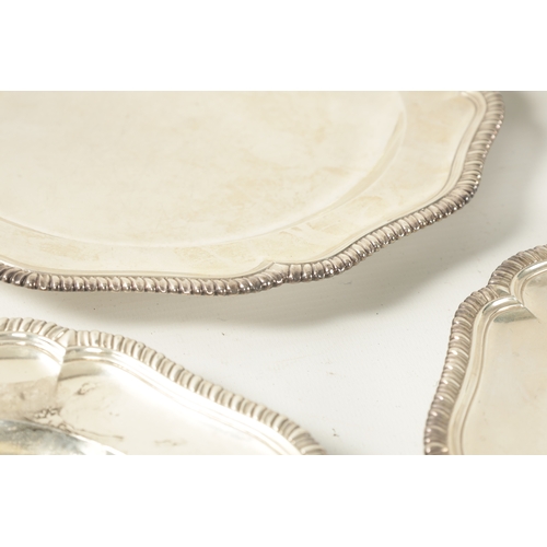 308 - A FINE SET OF TWELVE GEORGE III SILVER DINNER PLATES the plain armorial centres within scalloped fea... 