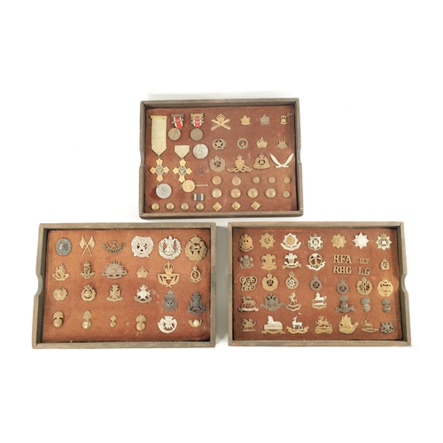 316 - A LARGE COLLECTION OF MILITARY MEDALS AND HAT BADGES displayed on three velvet lined trays