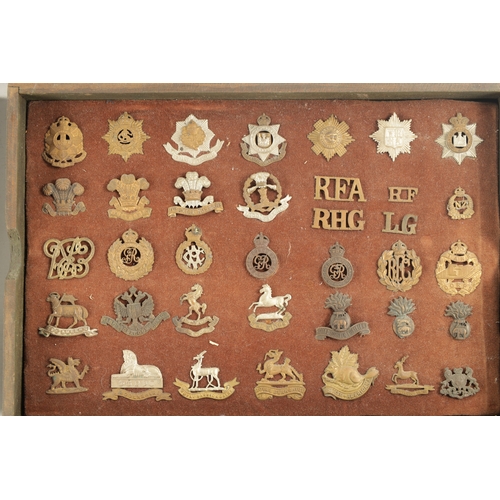 316 - A LARGE COLLECTION OF MILITARY MEDALS AND HAT BADGES displayed on three velvet lined trays