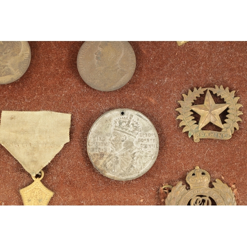 316 - A LARGE COLLECTION OF MILITARY MEDALS AND HAT BADGES displayed on three velvet lined trays