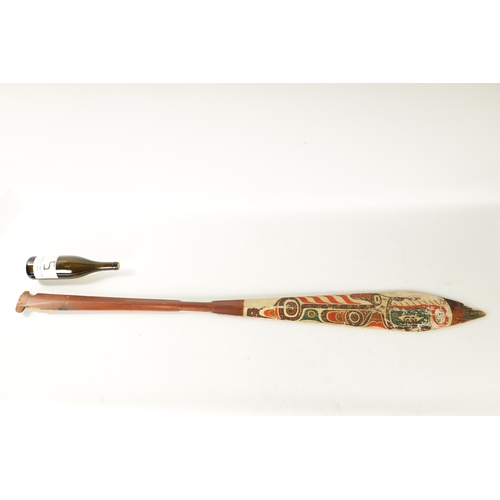 318 - A 19TH CENTURY AMERICAN TRIBAL STAINED SOFTWOOD DANCE PADDLE with painted double-sided blade. (151cm... 